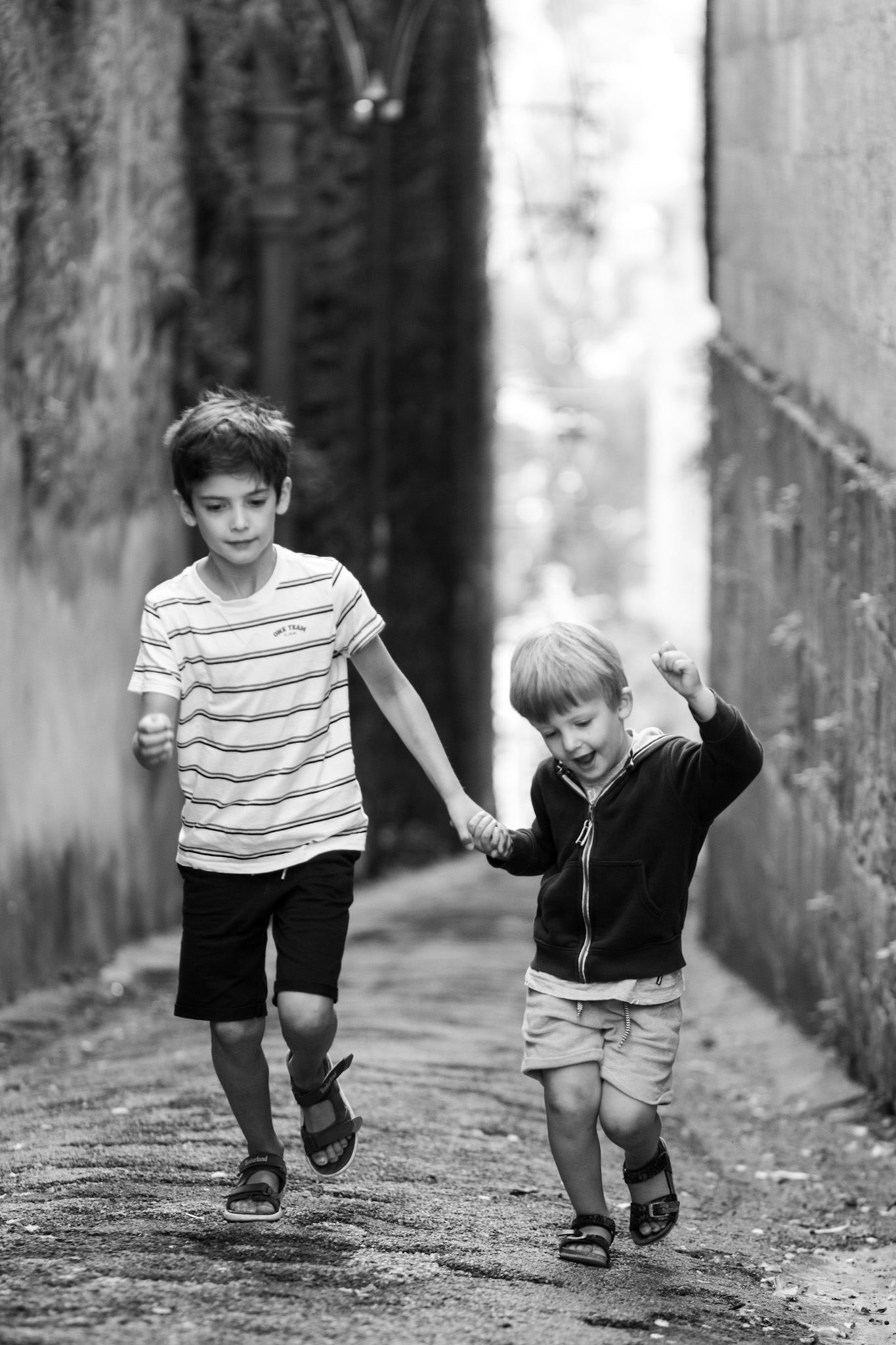 2 boys running in alley