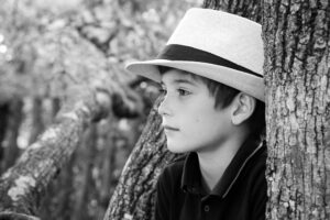 Close-up boy between trees, black and white